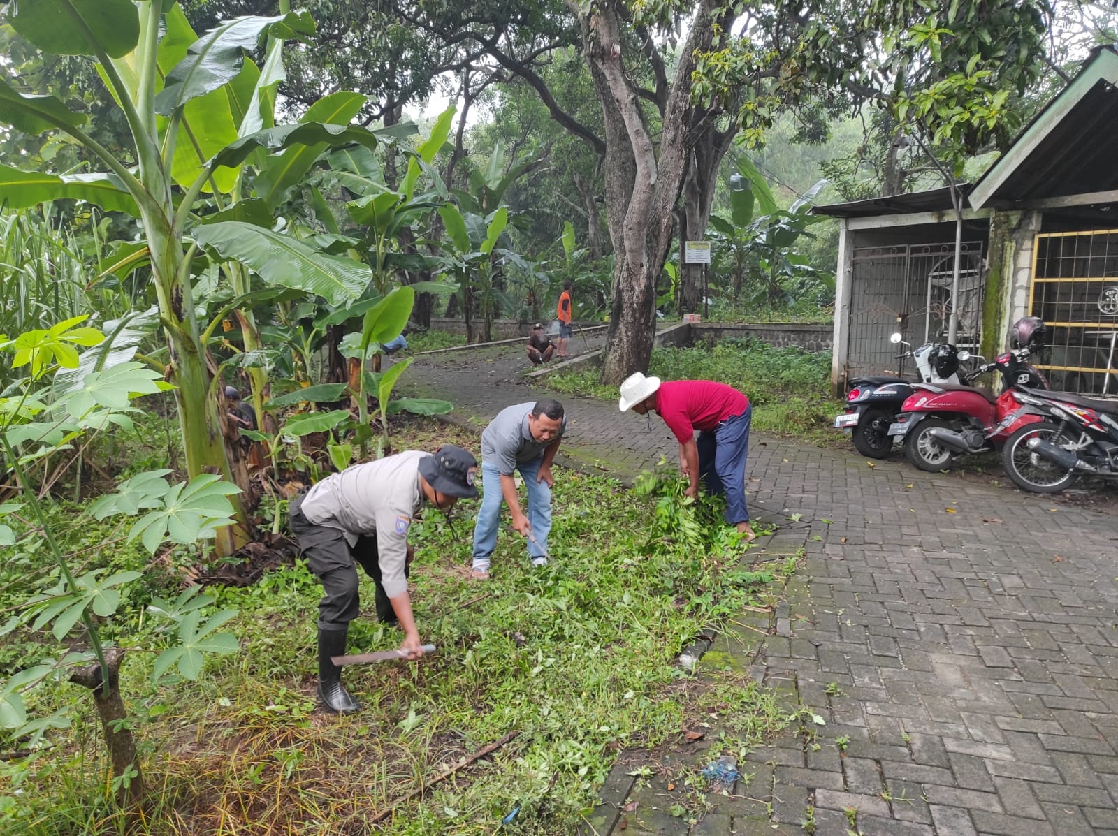 Bhabinkamtibmas Polsek Nganjuk Kota dan Warga Berbondong-bondong Bersihkan Makam Jelang Ramadhan